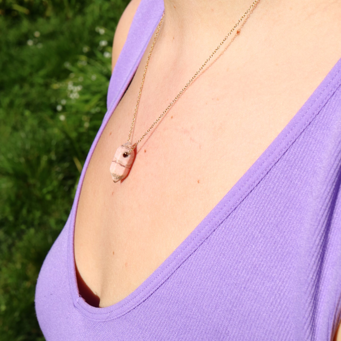 girl wearing gold necklace with crystal
