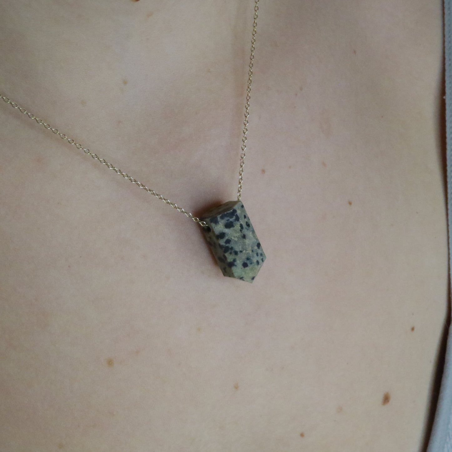Girl wearing Dalmatian Jasper crystal necklace
