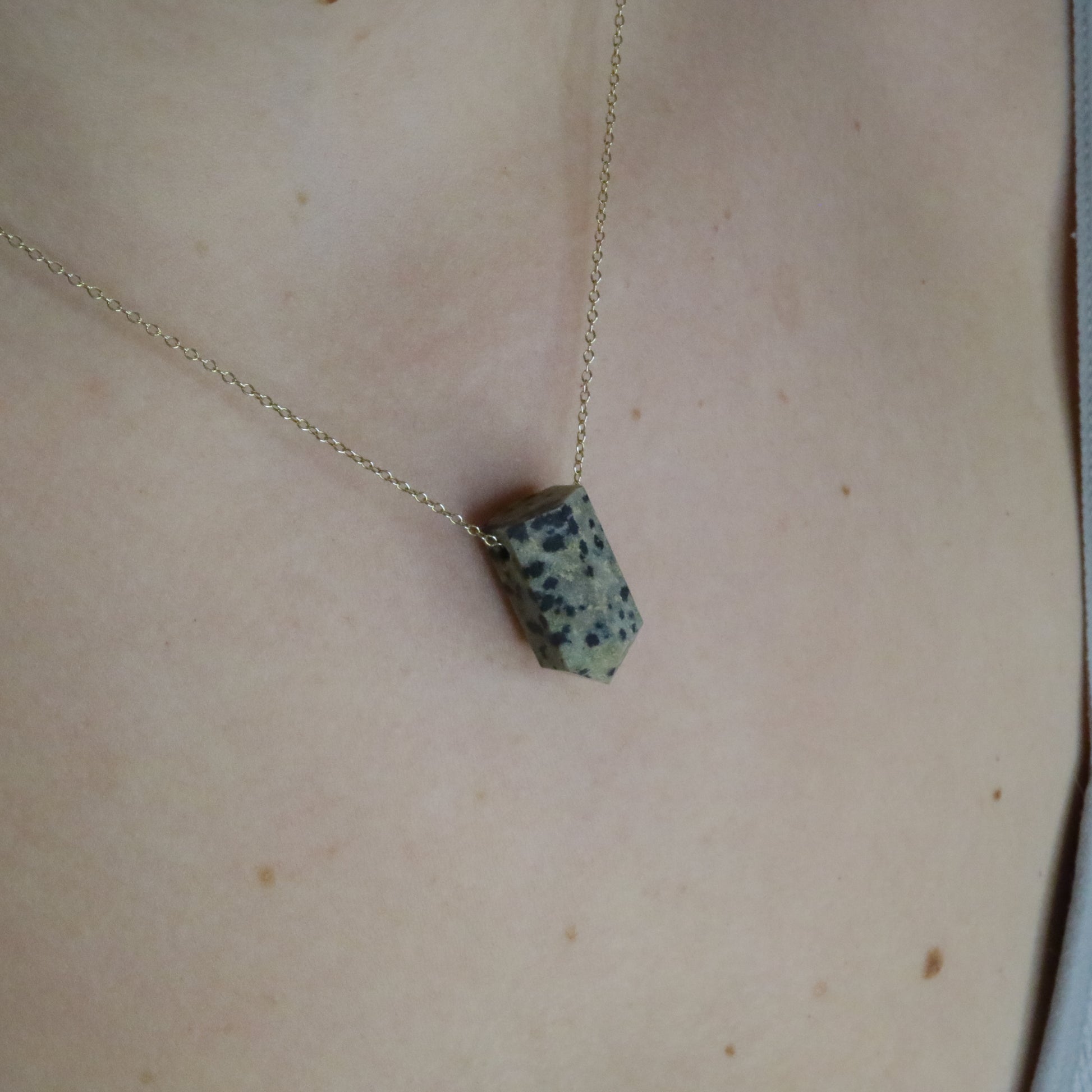 Girl wearing Dalmatian Jasper crystal necklace