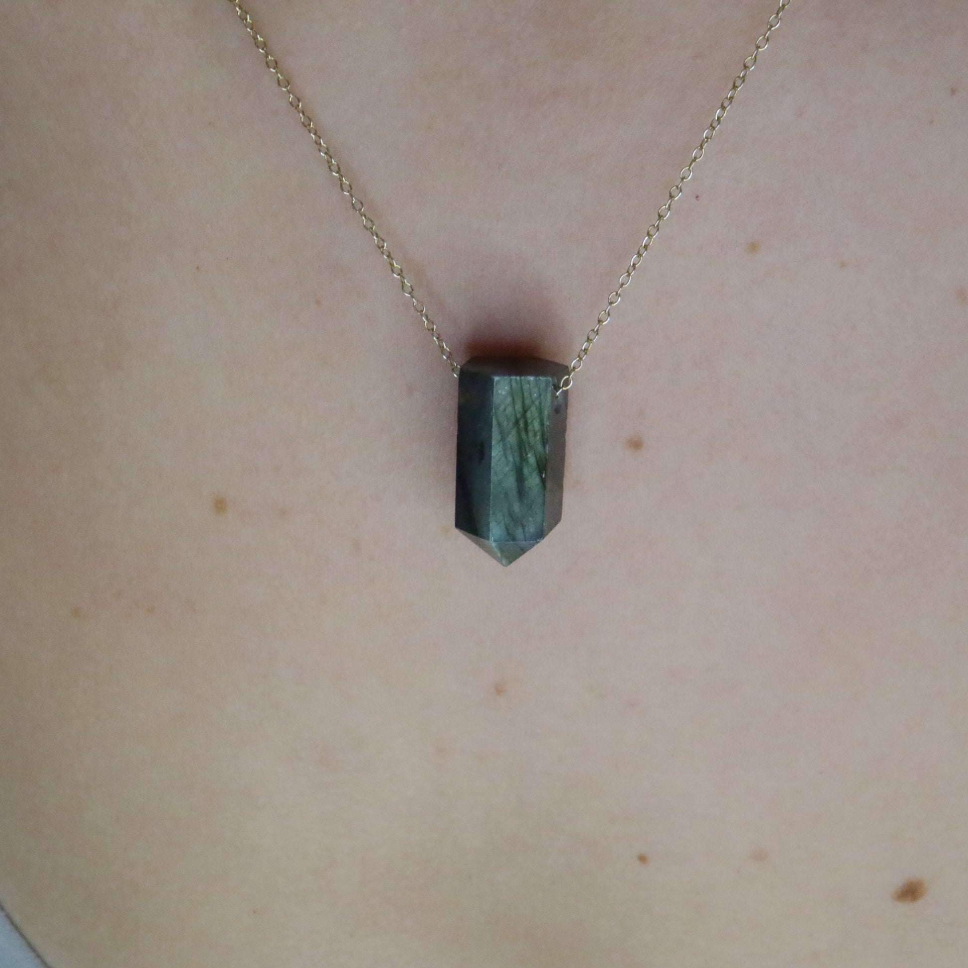 Girl wearing Labradorite crystal necklace