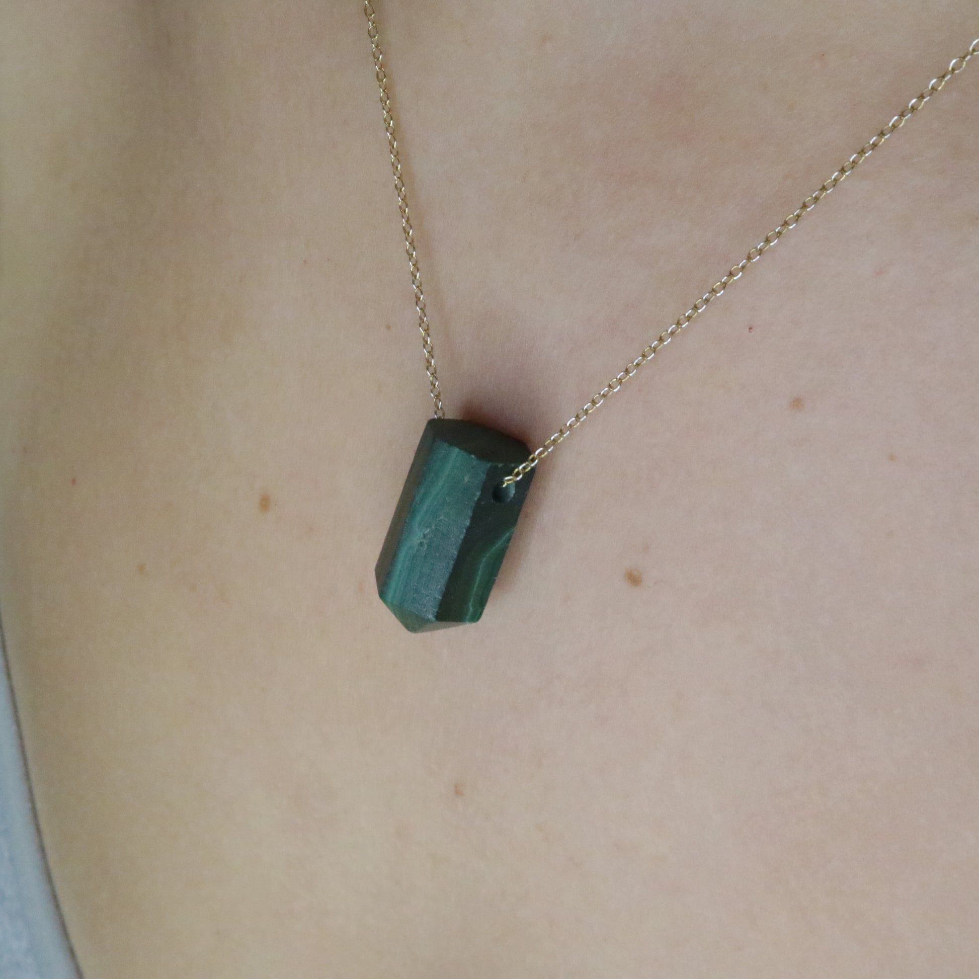 Girl wearing Malachite crystal necklace