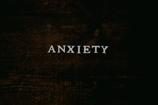 the word "anxiety" spelled out on wooden background