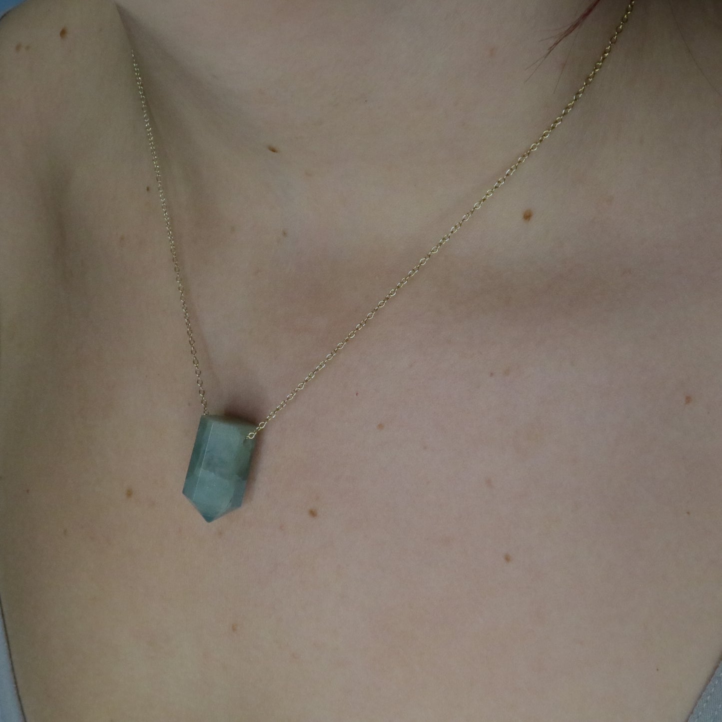 Girl wearing Aquamarine crystal necklace
