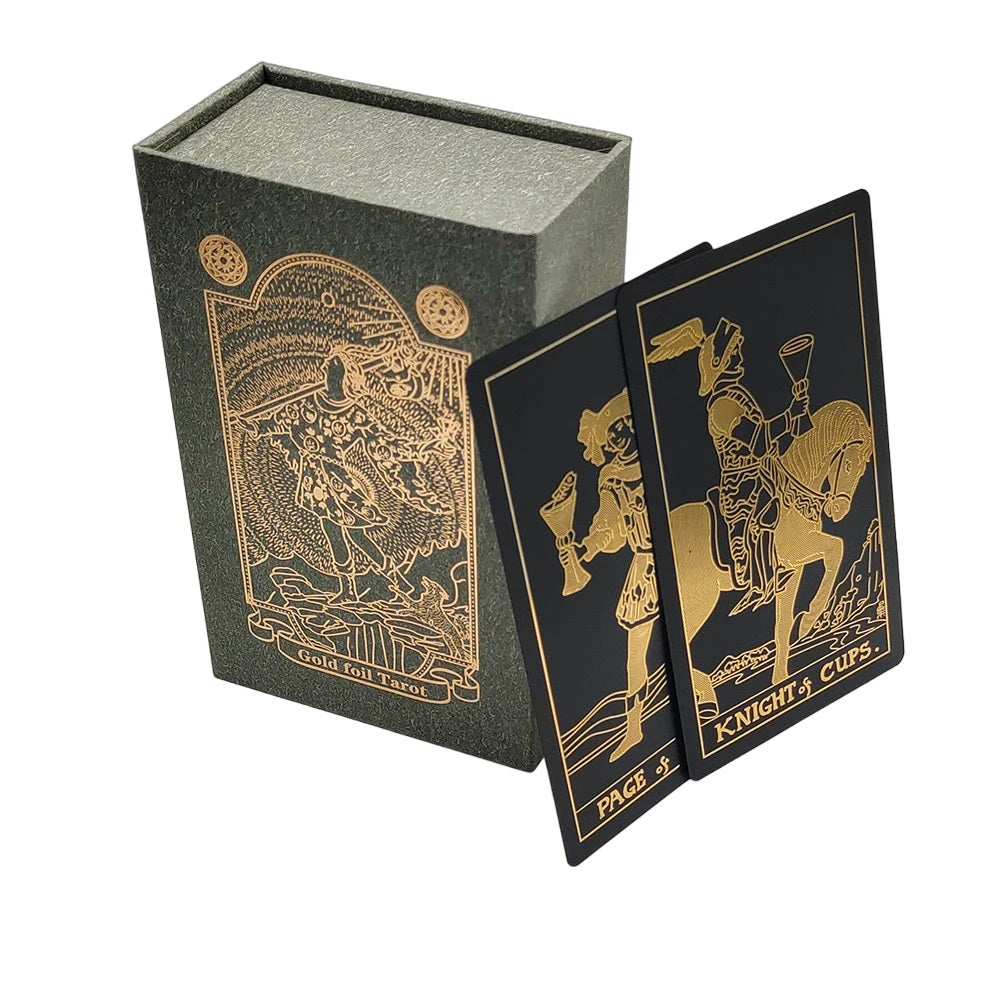 Two example tarot cards using gold outline on black background leaning on a box