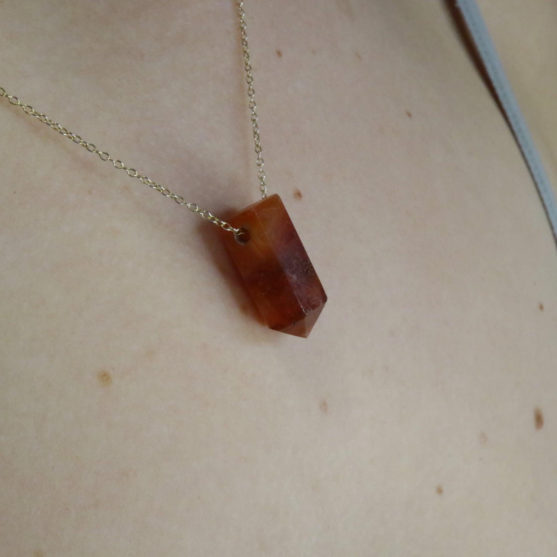 Girl wearing Carnelian crystal necklace