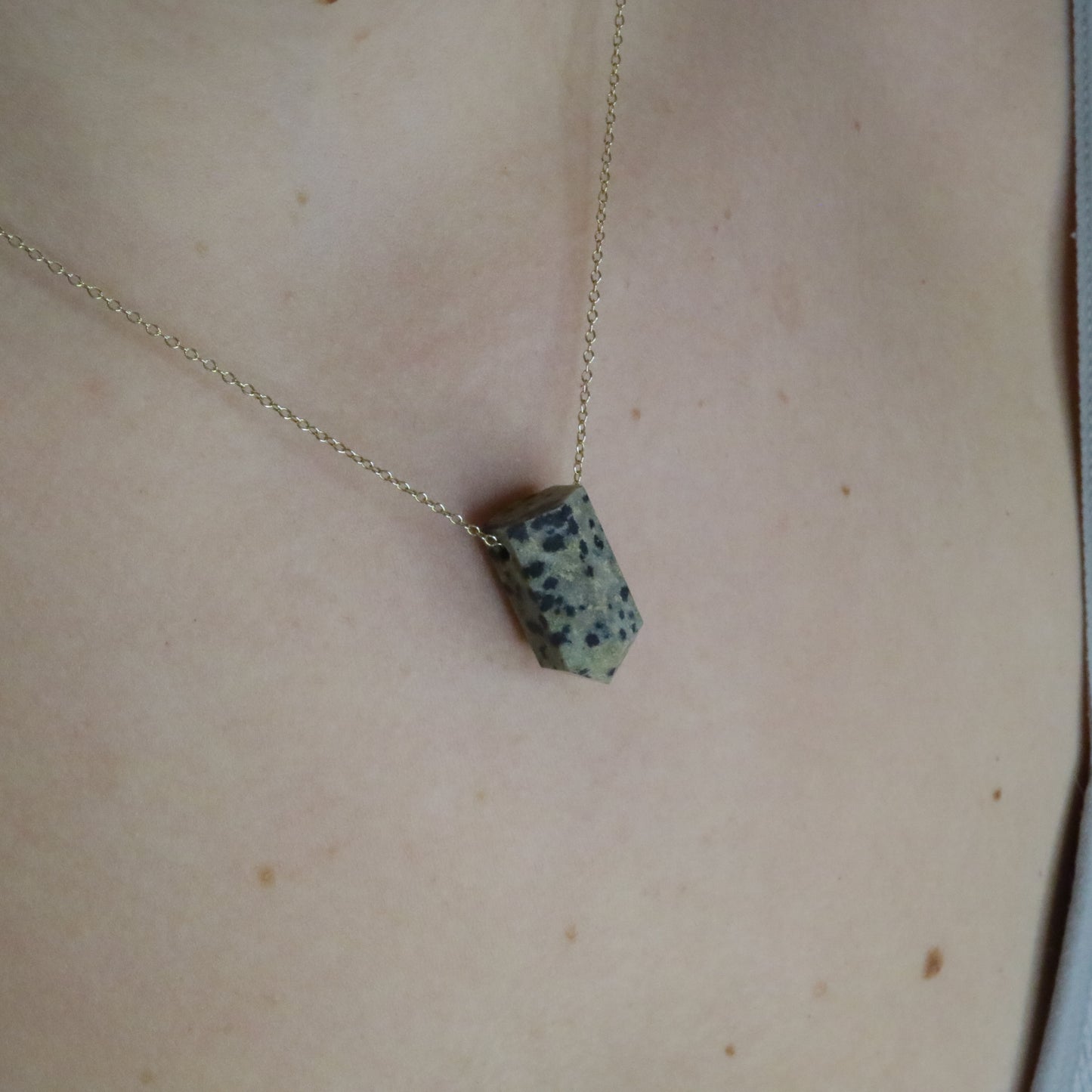 Girl wearing Dalmatian Jasper crystal necklace 