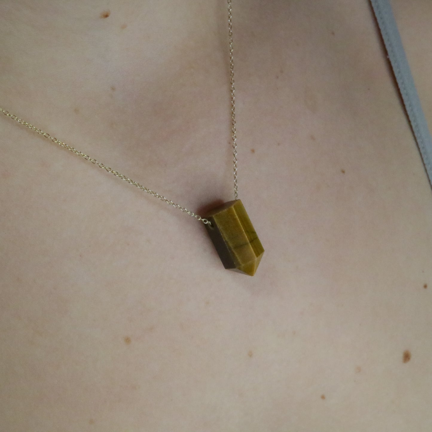 Girl wearing Tiger Eye crystal necklace 