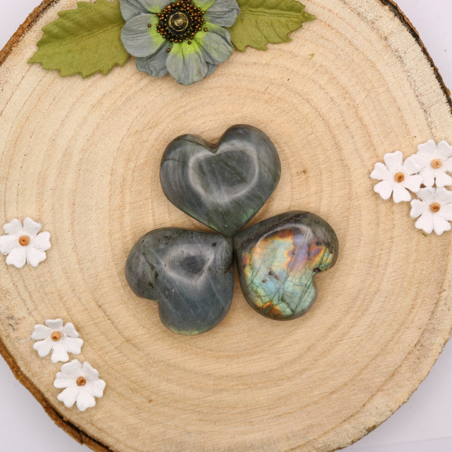 Three pieces of Labradorite crystal in the shape of a heart put together, top down view