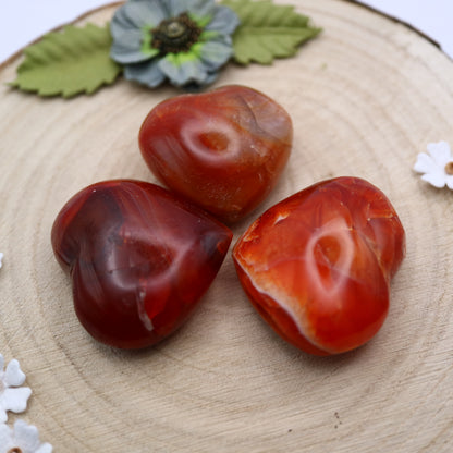 Three pieces of Carnelian crystal in the shape of a heart put together