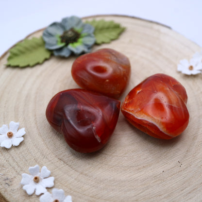 Three pieces of Carnelian crystal in the shape of a heart put together